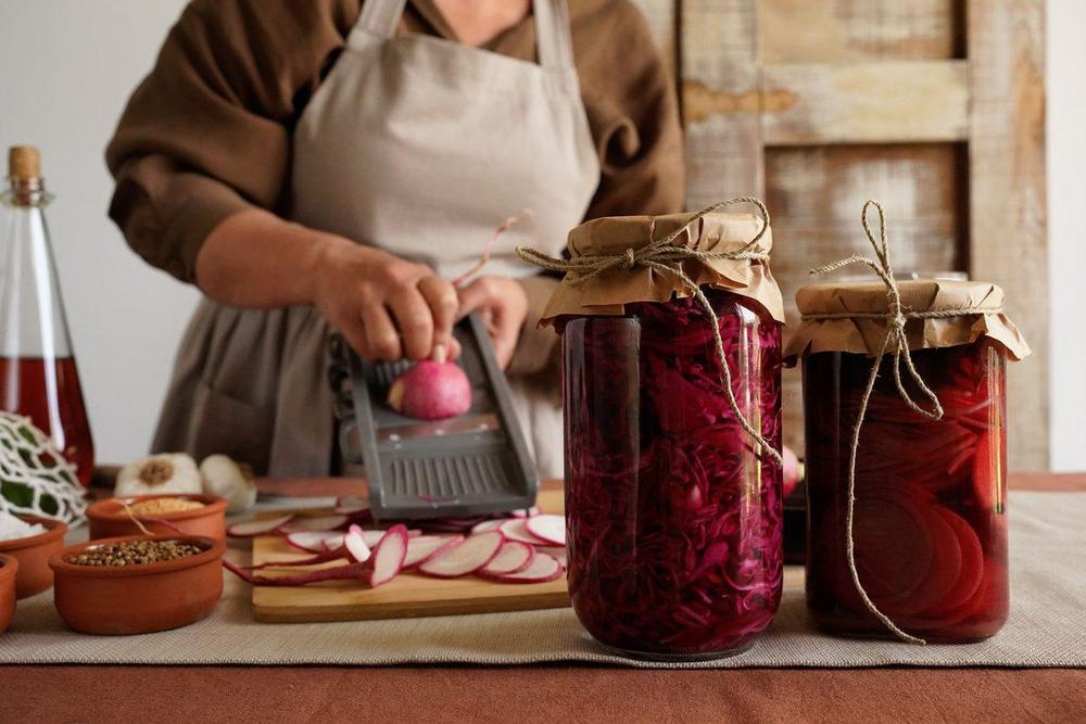 Two jars of homemade fermented red cabbage and beets with kraft paper lids