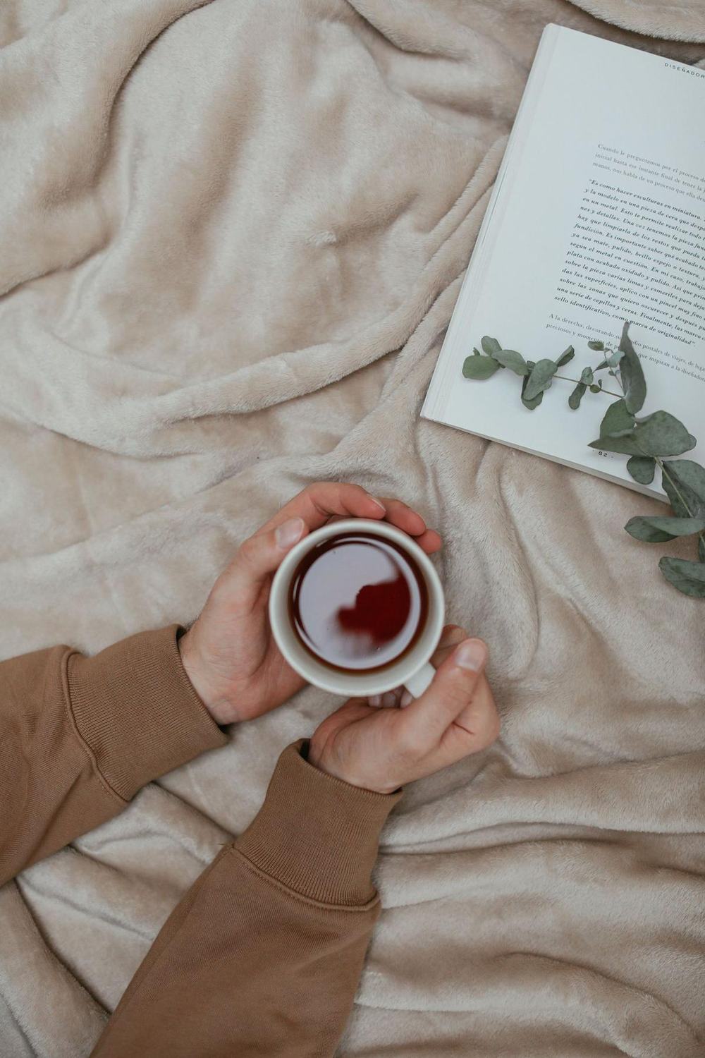Heated throw blanket with a cup of tea