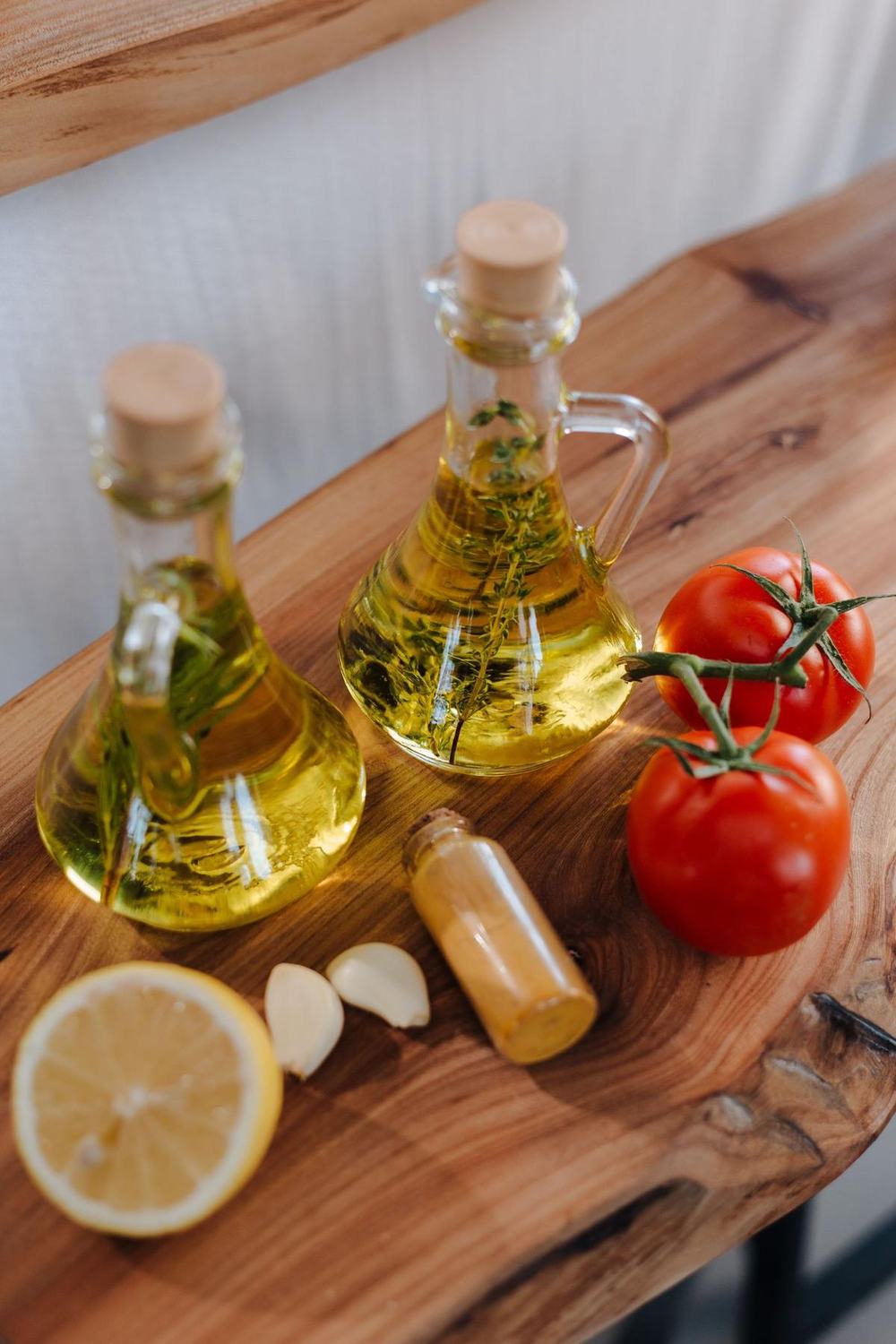 Glass oil bottles on a wooden board