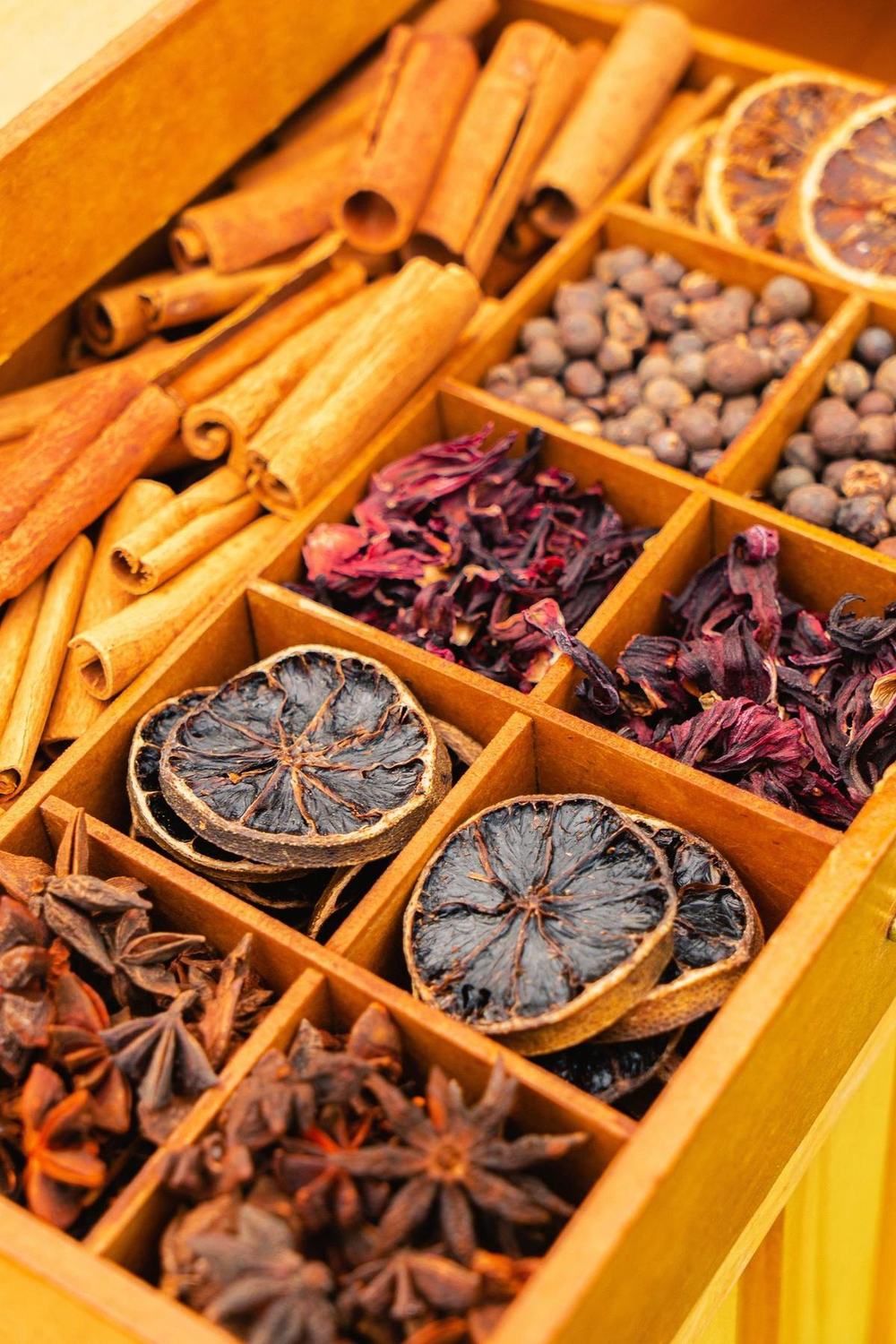 Wooden spice organizer with cinnamon and dried oranges