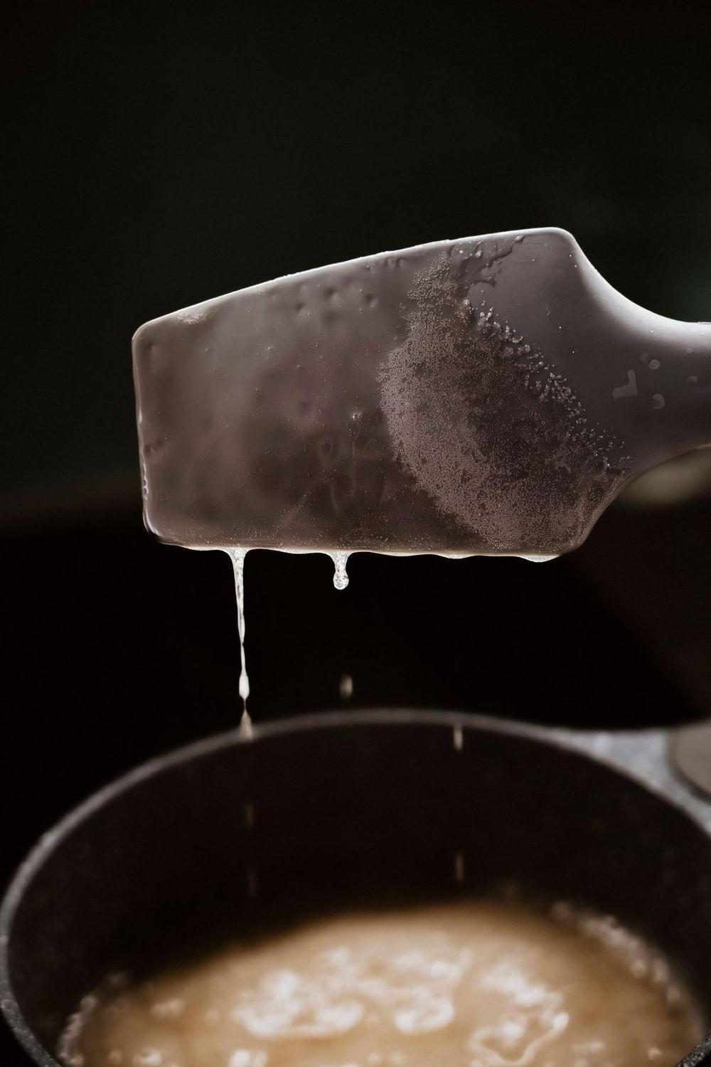 Silicone spoonula over a saucepan