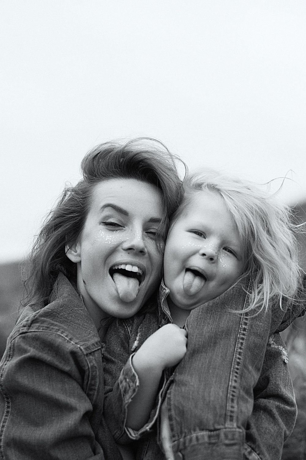 A mother and her small child laughing together, black and white