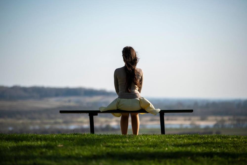 A woman alone on a bench